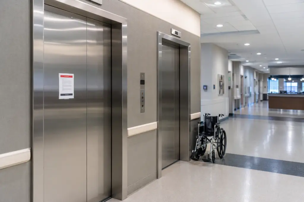 Out-of-service notice posted on a hospital elevator door in Texas, illustrating what happens when an elevator fails a TDI inspection at a healthcare facility.