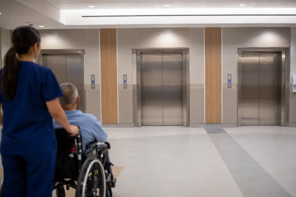 Hospital elevator lobby in a Texas healthcare building showing ADA-compliant elevator doors and call buttons, relevant to Texas elevator code compliance in 2026