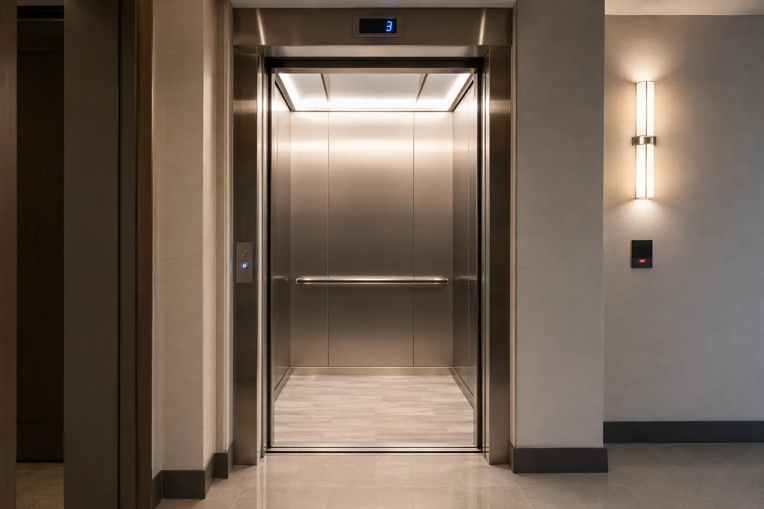 Modern elevator cab interior in a San Antonio residential condominium showing new fixtures, illustrating when a parts-and-labor elevator contract is the cost-effective choice for newer equipment