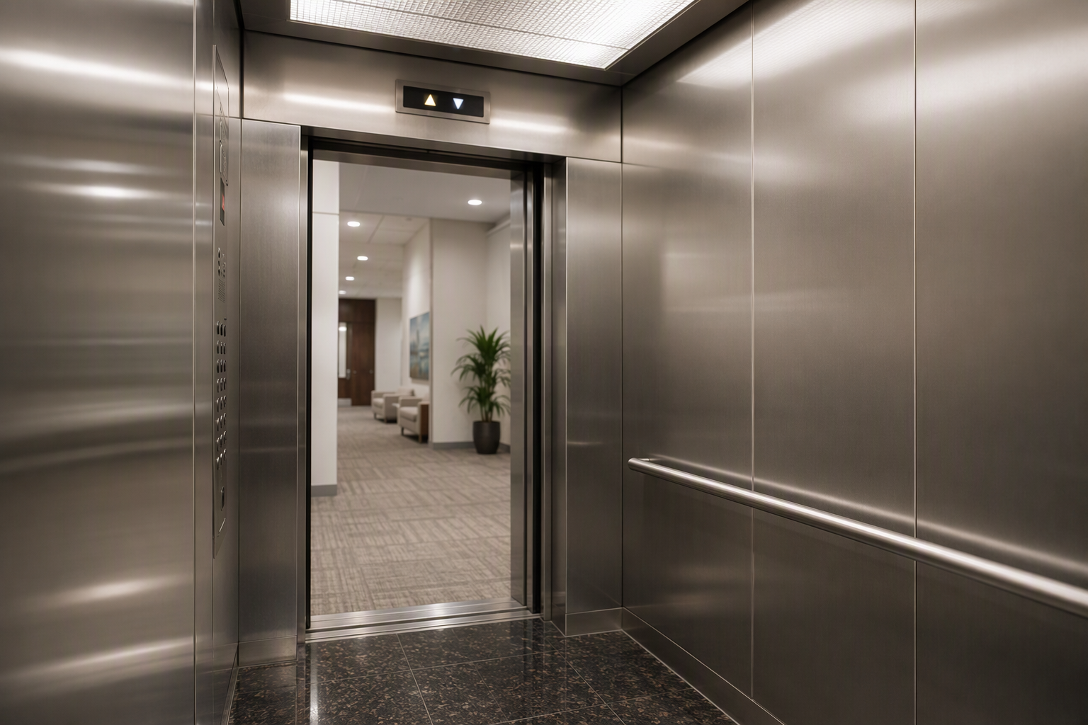 Modernized elevator cab interior with brushed stainless steel panels, LED lighting, and updated floor indicator in a Houston Texas commercial building.